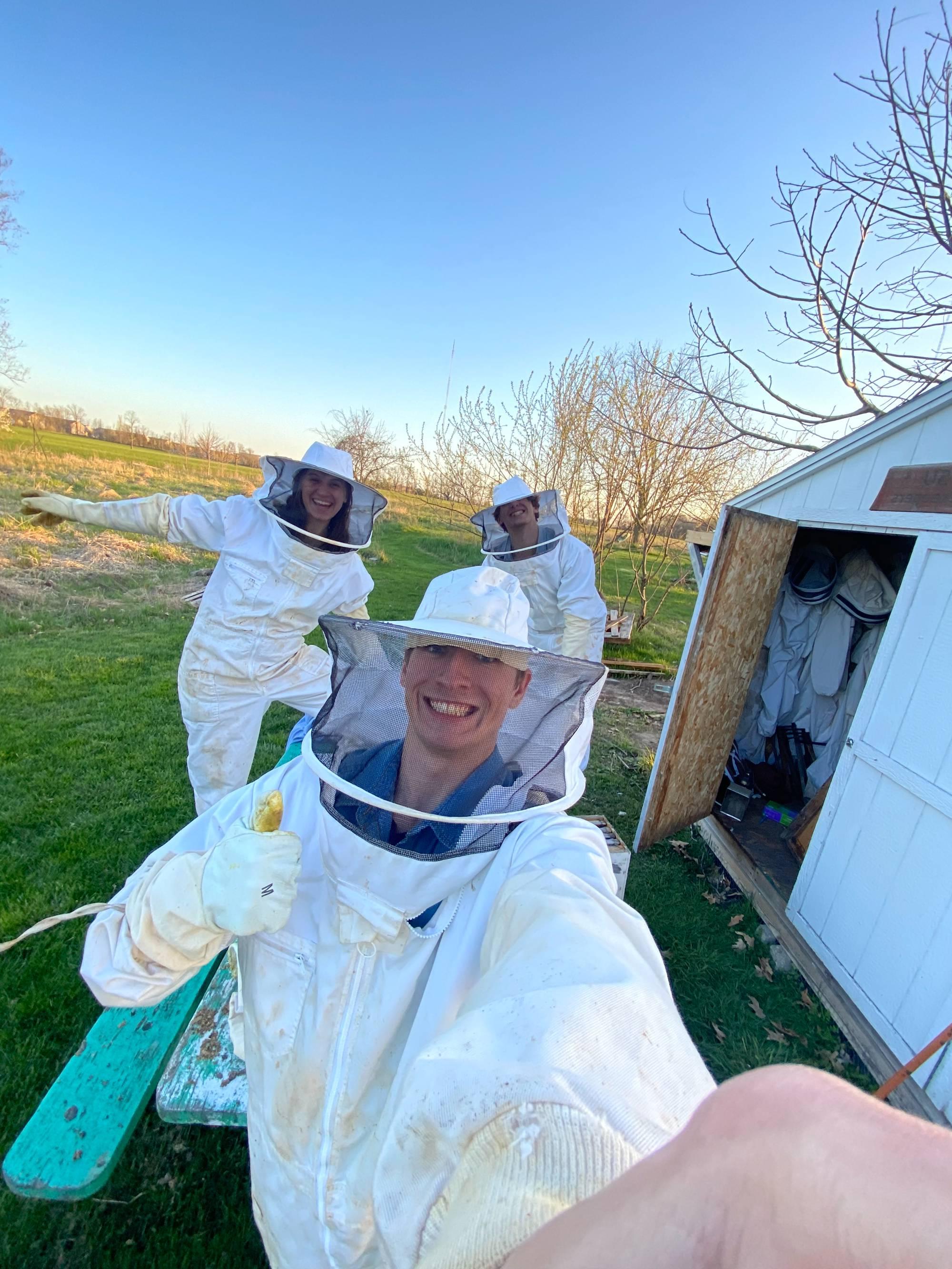 Three students in bee keeping outfits